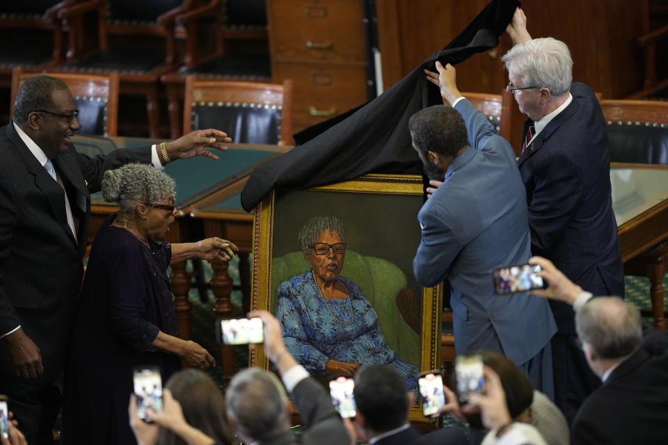 Opal Lee, second from left, who worked to help make Juneteenth a federally-recognized holiday, reacts with state Sen. Royce West, left, as her portrait is unveiled in the Texas Senate Chamber, Wednesday, Feb. 8, 2023, in Austin, Texas. (AP Photo/Eric Gay)