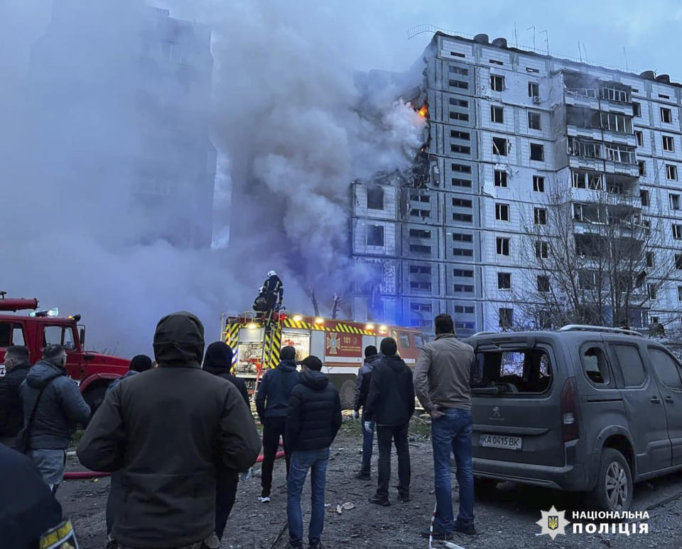 In this photo provided by the National Police of Ukraine, firefighters work to extinguish a fire after a Russian attack at an apartments' buildings area in the town of Uman, 200 kilometres (125 miles) south of Kiev, Ukraine, Friday, April 28, 2023. (National Police of Ukraine via AP)