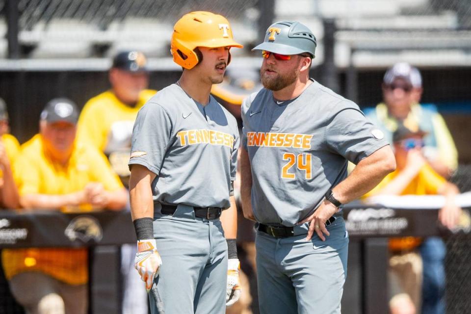 Tennessee assistant coach Josh Elander (24) speaks with Tennessee outfielder Hunter Ensley (9) during game one of the NCAA baseball super regional between Tennessee and Southern Mississippi held at Pete Taylor Park in Hattiesburg, Miss., on Sunday, June 11, 2023.