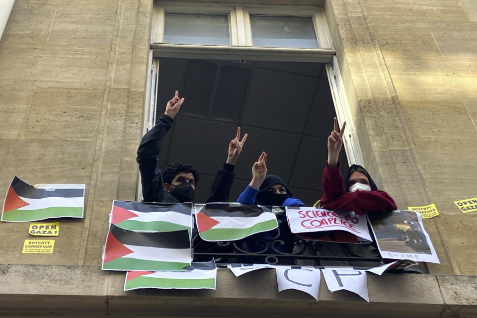 Students blocking the Sciences-Po university flash the V sign Friday, April 26, 2024 in Paris. Students at a prestigious university resumed pro-Palestinian protests on Friday, days after French police broke up a demonstration, inspired by Gaza solidarity encampments at campuses around the United States. Dozens of students the Sciences-Po university blocked an entrance to a campus building in central Paris with chairs and bikes. (AP Photo/Jeffrey Schaeffer)