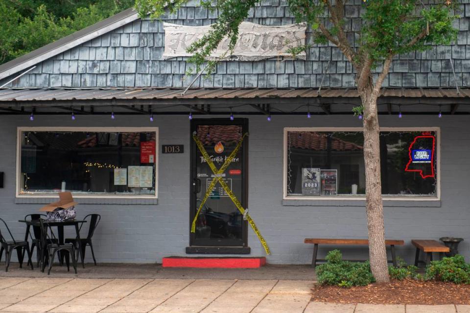 Crime scene tape still decorates The Scratch Kitchen bar and restaurant in Ocean Springs on Monday, May 8, 2023, after a shooting killed one at the restaurant on Friday.