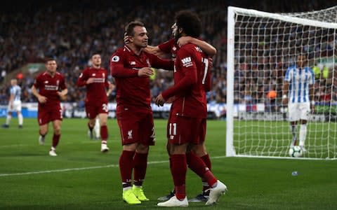 Mohamed Salah of Liverpool(R) celebrates with Adam Lallana of Liverpool(hidden) and Xherdan Shaqiri of Liverpool(L) after scoring his sides first goal during the Premier League match between Huddersfield Town and Liverpool FC - Credit: Mark Robinson/Getty Images