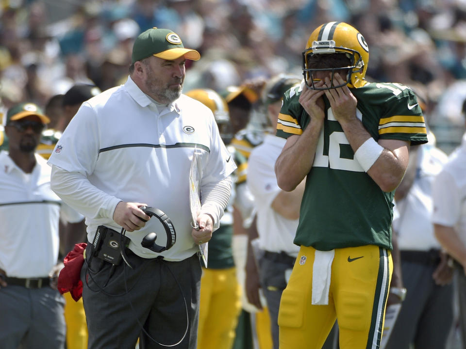 FILE - In this Sept. 11, 2016, file photo, Green Bay Packers head coach Mike McCarthy and quarterback Aaron Rodgers (12) chat on the sideline during the second half of an NFL football game against the Jacksonville Jaguars in Jacksonville, Fla. McCarthy is confident that Rodgers and Green Bay’s struggling offense will get better. Two games into the season, the results have been uncharacteristically ugly. (AP Photo/Phelan M. Ebenhack, File)