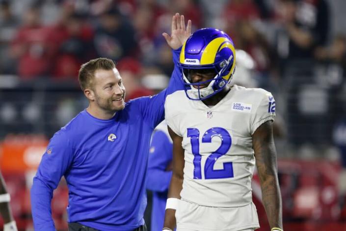 Los Angeles Rams head coach Sean McVay, left, smiles as he slaps the helmet of wide receiver Van Jefferson (12) prior to an NFL football game against the Arizona Cardinals, Monday, Dec. 13, 2021, in Glendale, Ariz. (AP Photo/Ralph Freso)