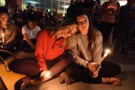 <p>Lindsay Cotterman (L) and Shawna Pieruschka attend a candlelight vigil at the University of Las Vegas student union October 2, 2017, after a gunman killed at least 58 people and wounded more than 500 others when he opened fire on a country music concert in Las Vegas, Nevada late October 1, 2017. (Photo: Robyn Beck/AFP/Getty Images) </p>