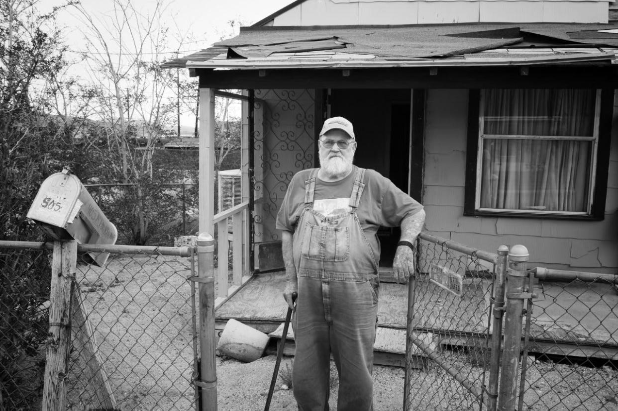 Ira Gwin owns Hillside Apartments in Barstow and is a longtime resident of the city. Here, he is photographed by Lara Hartley in front of his rental homes before a remodeling he did in 2014.