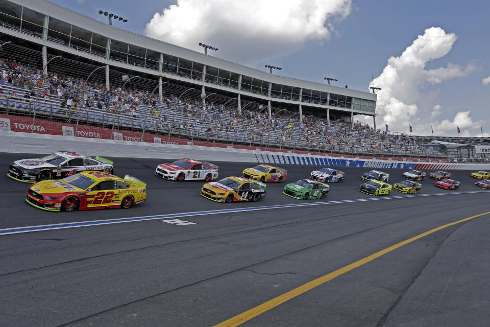 FILE - In this Sept. 29, 2019, file photo cars drive through Turn 4 to start the NASCAR Cup Series auto race at Charlotte Motor Speedway in Concord, N.C. General Motors is planning to open a new technical center for performance and auto racing near the Charlotte Motor Speedway. The center will focus on transferring auto racing knowledge into engineering for vehicles that are sold to the public. (AP Photo/Gerry Broome, File)