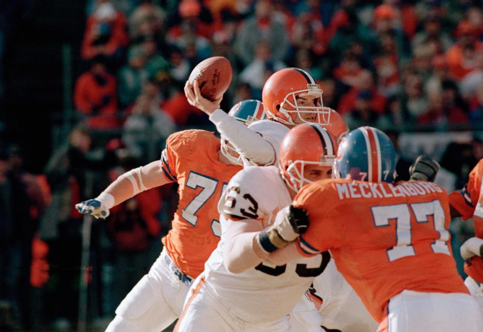 Browns right tackle Cody Risien (63) blocks against  Broncos linebacker Karl Mecklenburg as quarterback Bernie Kosar cocks his arm to throw during the second quarter of the AFC Championship game in Denver, Jan. 17, 1988. (AP Photo/Mark Duncan)