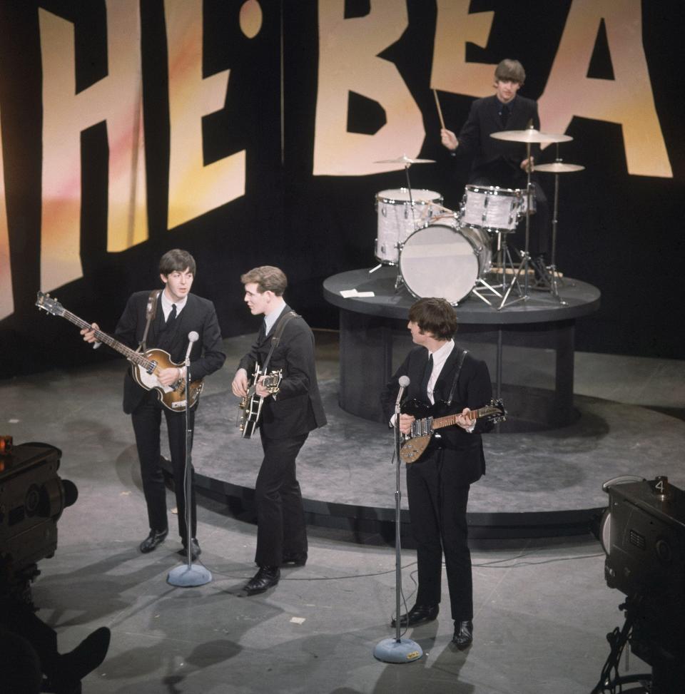 British rock band the Beatles are shown during rehearsals on the set of the Ed Sullivan Show in New York, Feb. 8, 1964. On the drums is Ringo Starr, and in the front, left to right, are bassist Paul McCartney, an unidentified stand-in for George Harrison, and singer John Lennon. (AP Photo)
