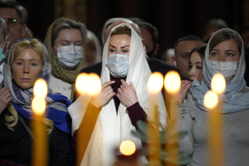Russian Orthodox believers attends the Christmas Liturgy in the Christ the Saviour Cathedral in Moscow, Russia, Friday, Jan. 7, 2022. Parishioners wearing face masks to protect against coronavirus, observed social distancing guidelines as they attended the liturgy. Orthodox Christians celebrate Christmas on Jan. 7, in accordance with the Julian calendar. (AP Photo/Alexander Zemlianichenko)