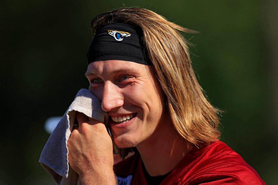 Jacksonville Jaguars quarterback Trevor Lawrence (16) wipes sweat as he talks to fellow quarterbacks during day 9 of the Jaguars Training Camp Tuesday, Aug. 2, 2022 at the Knight Sports Complex at Episcopal School of Jacksonville. 