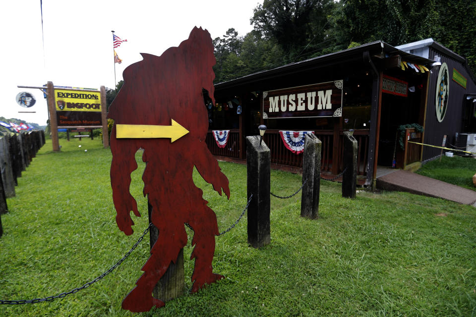 In this Aug. 8, 2019, photo, a cutout of a Bigfoot directs visitors to the entrance of Expedition: Bigfoot! The Sasquatch Museum in Cherry Log, Ga. The owner of this intriguing piece of Americana at the southern edge of the Appalachians is David Bakara, a longtime member of the Bigfoot Field Researchers Organization who served in the Navy, drove long-haul trucks and tended bar before opening the museum in early 2016 with his wife, Malinda. (AP Photo/John Bazemore)