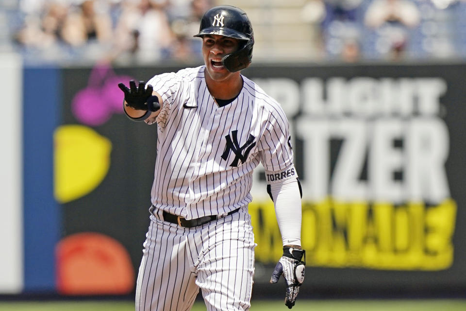 New York Yankees Gleyber Torres gestures from second base after hitting a two-run double during the first inning of a baseball game against the Chicago White Sox, Sunday, May 23, 2021, at Yankee Stadium in New York. (AP Photo/Kathy Willens)