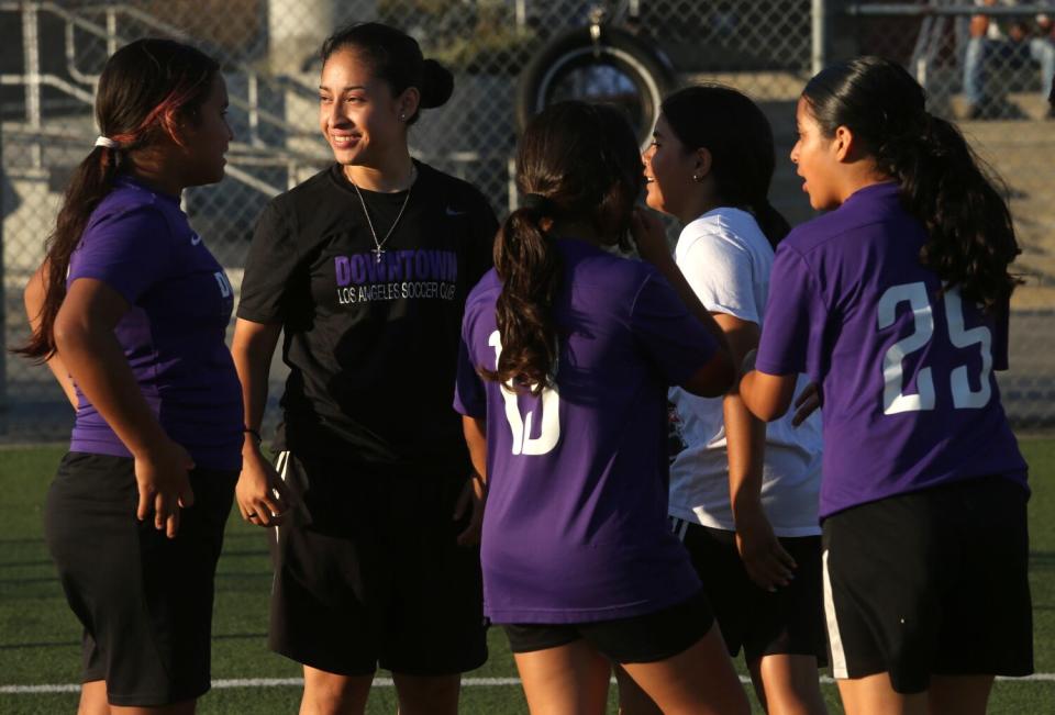 Nayelli Barahona smiles as she coaches players in the Downtown L.A. Soccer Club