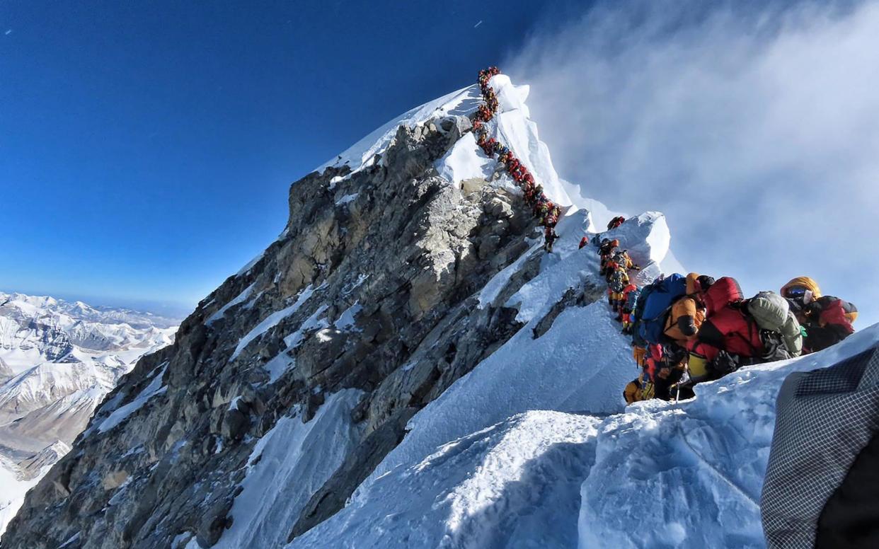 Heavy traffic of mountain climbers lining up to stand at the summit of Mount Everest in May - AFP