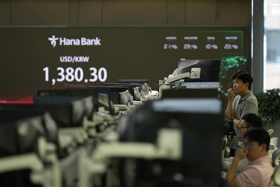 Currency traders watch computer monitors near the screens showing the foreign exchange rate between U.S. dollar and South Korean won at a foreign exchange dealing room in Seoul, South Korea, Friday, May 31, 2024. (AP Photo/Lee Jin-man)