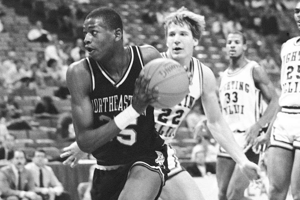 FILE - Northeastern's Reggie Lewis (35) moves the ball past Illinois' Doug Altenberger (22) during first round play in the NCAA East Regionals at Atlanta, March 15, 1985. Led by future NBA All-Star Reggie Lewis, Northeastern broke in at No. 19 in the first regular-season poll of the 1986-87 season. (AP Photo/Joe Holloway Jr., File