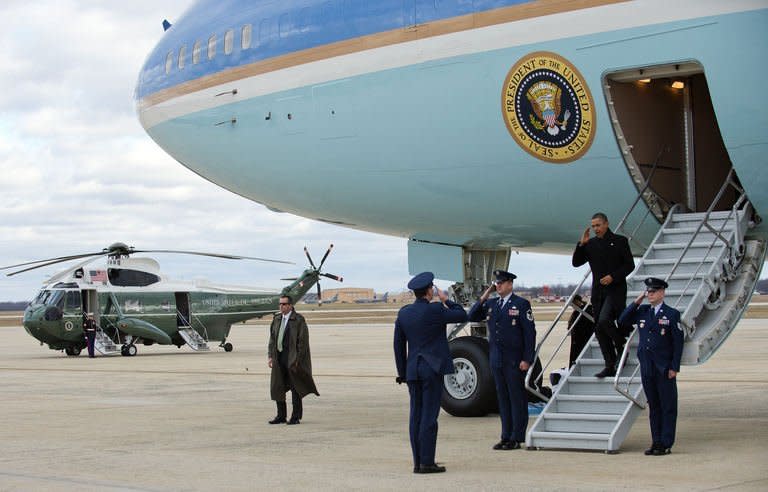 US President Barack Obama salutes as he walks off Air foirce One upon his landing at Andrews Air force Base, Maryland, on December 27, 2012. Obama will host top congressional leaders including his bitter Republican rivals on Friday in a last-ditch bid to halt America's slide over the so-called "fiscal cliff."