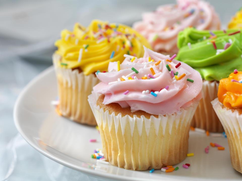 Assorted cupcakes with colorful frosting and sprinkles on a plate