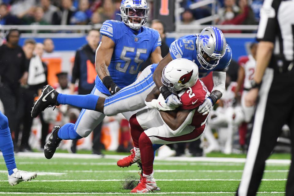 Cardinals running back Chase Edmonds is stopped by Lions outside linebacker Charles Harris during the second half on Sunday, Dec. 19, 2021, at Ford Field.