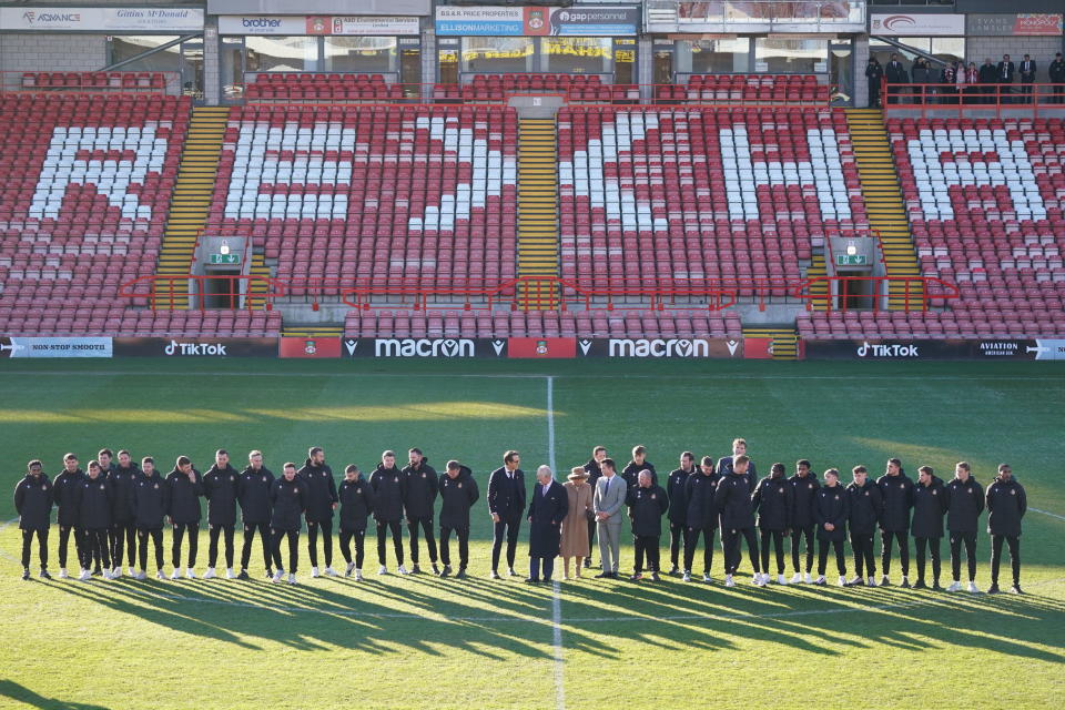 Britain's King Charles III and Camilla, the Queen Consort meet Wrexham Soccer team co owners, US actors Ryan Reynolds and Rob McElhenney and players during their visit to Wrexham Association Football Club's Racecourse Ground, in Wrexham, England, Friday, Dec. 9, 2022. (Jacob King/PA via AP)