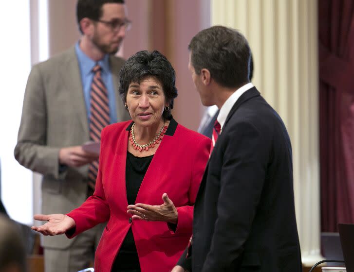 Assemblywoman Susan Talamantes Eggman, D-Stockton, discusses her bill allowing people to inject drugs in supervised facilities with Sen. Ted Gaines, R-El Dorado Hills, as the Senate debated the measure, Tuesday, Sept. 12, 2017, in Sacramento, Calif. Gaines joined other Republicans in voting agains the bill, AB186. (AP Photo/Rich Pedroncelli)