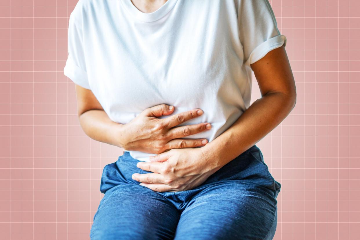 A woman grabbing her stomach on a designed background