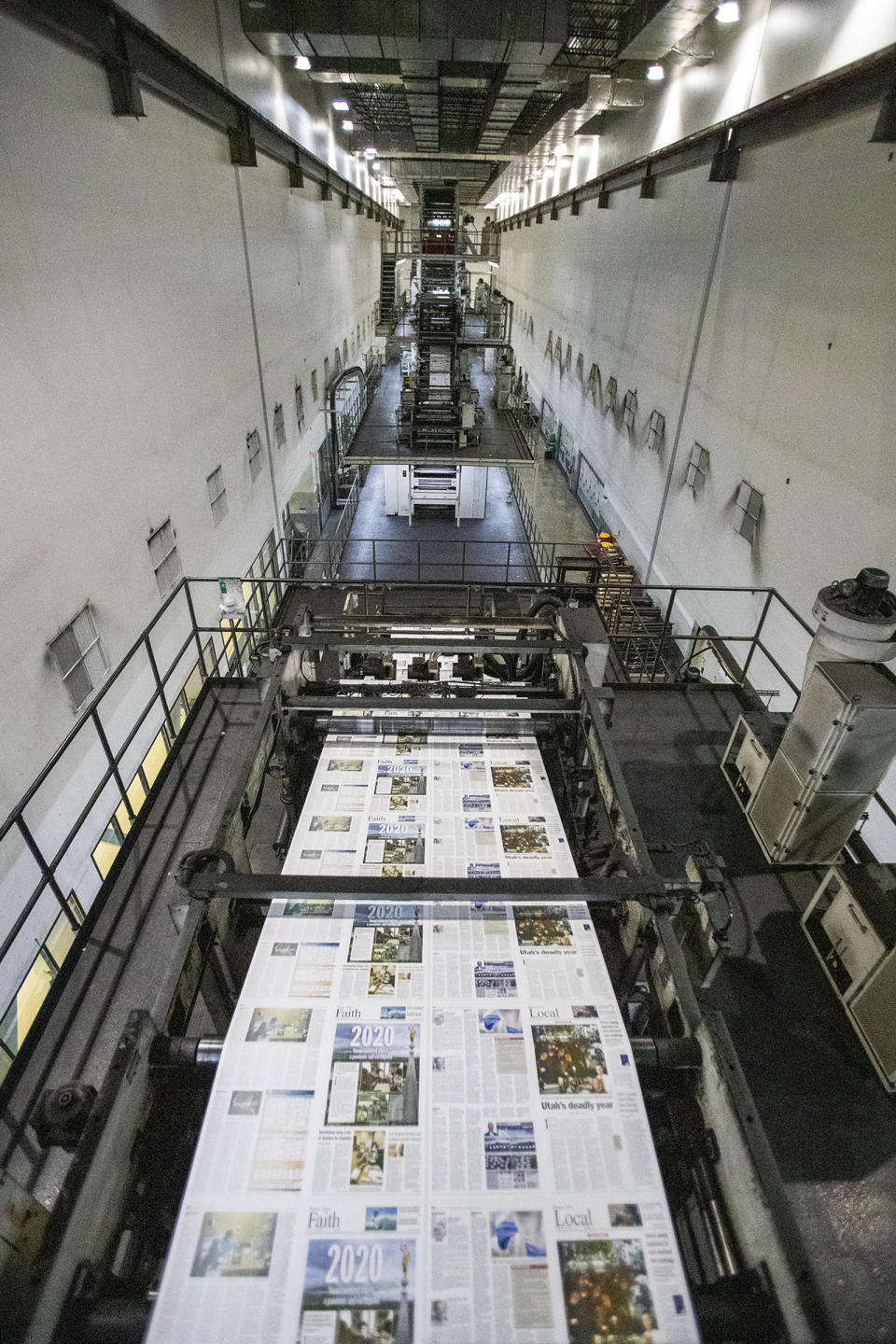 The presses begin rolling as the last daily edition of the Deseret News is printed at the MediaOne building in West Valley City, Utah, on Wednesday, Dec. 30, 2020. Both of Salt Lake City's major newspapers released their final daily print editions Thursday as the two publications transition to weekly editions. The Salt Lake Tribune, which won the Pulitzer Prize for local reporting in 2017, will continue to publish breaking stories online every day. The 170-year-old Deseret News in the state capital will also shift its attention online and offer a monthly magazine which will debut in January. (Scott G Winterton/The Deseret News via AP)