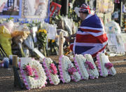 <p>A royal fan for the late Diana, Princess of Wales, stands outside Kensington Palace to pay tribute to her in London, Aug. 31, 2017. (Photo: Frank Augstein/AP) </p>