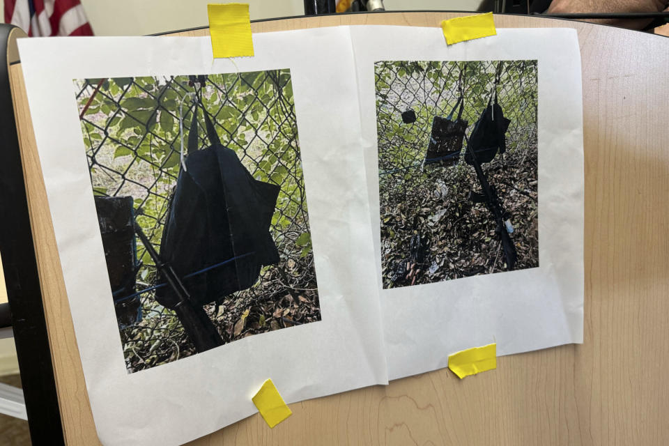 Photos showing an AK-47 rifle, a backpack and a Go-Pro camera on a fence outside Trump International Golf Club, taken after an alleged assassination attempt on Republican presidential candidate and former President Donald Trump, are displayed during a news conference at the main branch of the Palm Beach County Library, Sunday, Sept. 15, 2024, in West Palm Beach, Florida. (AP Photo/Stephany Matat)