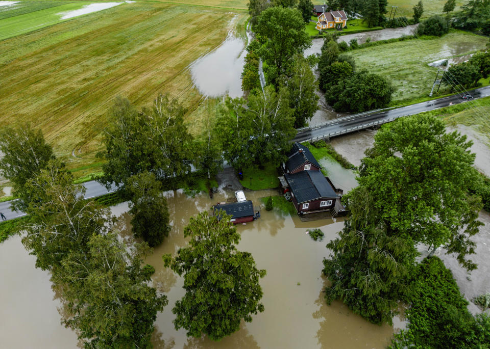 Flooded houses in Lena, Norway, Tuesday, Aug. 8, 2023. Norwegian authorities warned Tuesday to prepare for “extremely heavy rainfall” in the area after Storm Hans caused injuries, ripped off roofs and upended summertime life in northern Europe. (Stian Lysberg Solum/NTB Scanpix via AP)