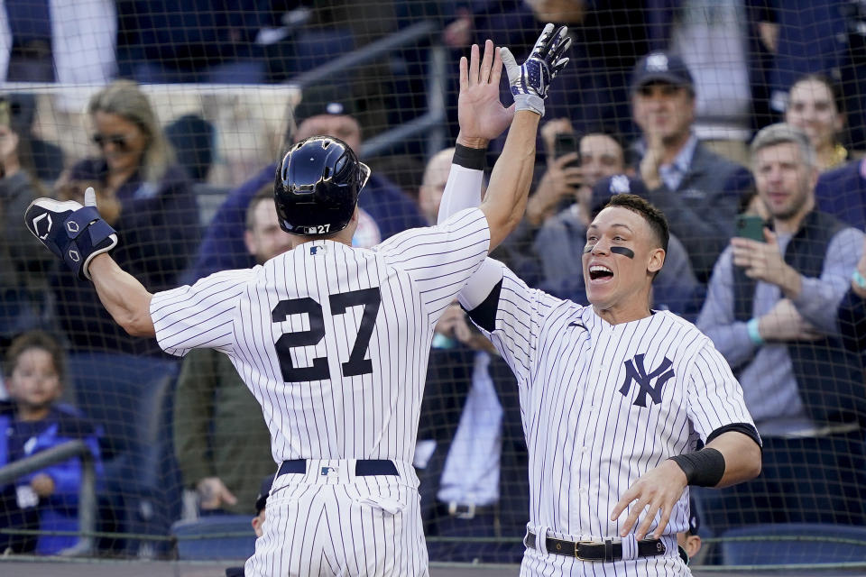 New York Yankees Giancarlo Stanton (27) celebrates with Aaron Judge after hitting a three-run home run against the Cleveland Guardians during the first inning of Game 5 of an American League Division baseball series, Tuesday, Oct. 18, 2022, in New York. (AP Photo/John Minchillo)