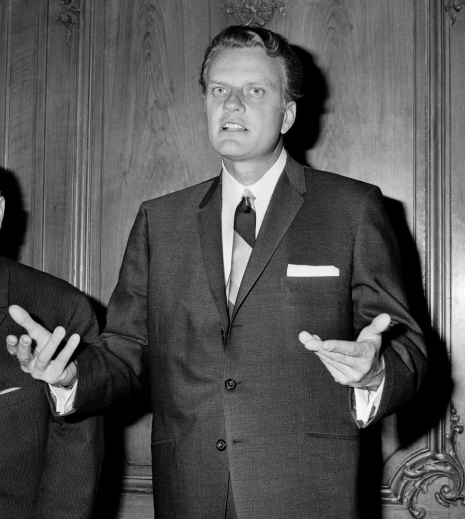 PARIS, FRANCE:  Billy Graham, the American evangelist, preaches 13 May 1963 in Paris in front of an estimated crowd of 10,0000 faithful. Graham, (son of a dairy farmer, born in 1918 in Charlotte, NC), attended Florida Bible Institute and was ordained a Southern Baptist minister in 1939 and quickly gained a reputation as a preacher. During the 1950s he conducted a series of highly organized revivalist campaigns in the USA and UK, and later in South America, the USSR and Western Europe. (Photo credit should read AFP/Getty Images)