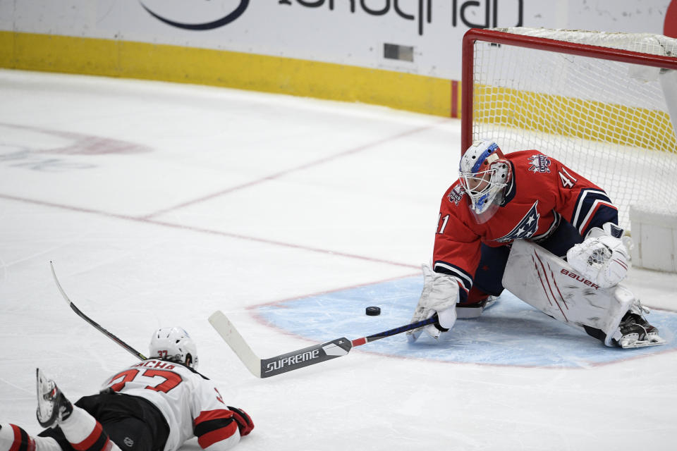 Washington Capitals goaltender Vitek Vanecek (41) defends on a shot by New Jersey Devils center Pavel Zacha (37) during the first period of an NHL hockey game Tuesday, March 9, 2021, in Washington. (AP Photo/Nick Wass)