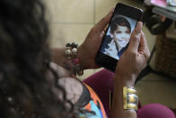 Rajee Narinesingh, a transgender woman, holds a photograph of herself as a child, Thursday, June 29, 2023, in Fort Lauderdale, Fla. In spite of several roadblocks, the 56-year-old Florida actress and activist has seen growing acceptance since she first came out decades ago. (AP Photo/Lynne Sladky)