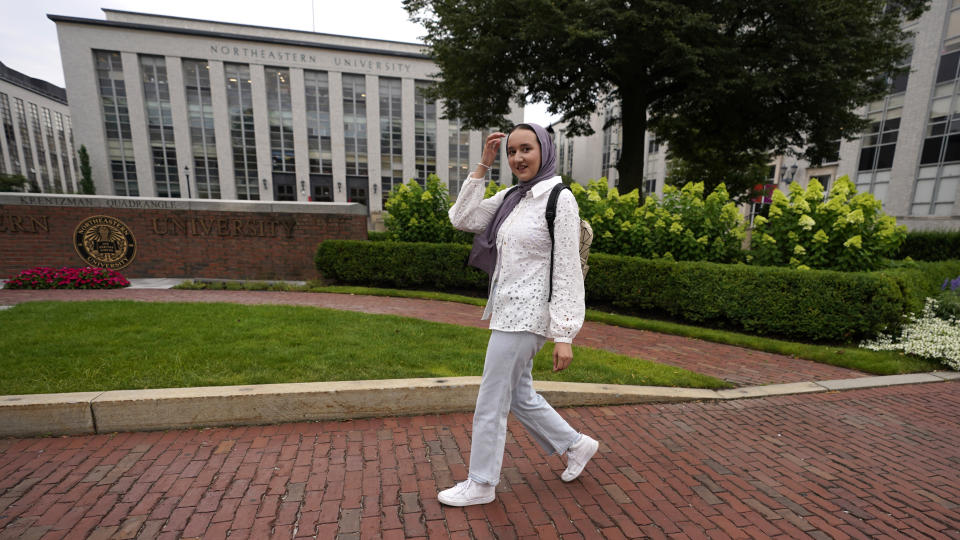 Northeastern University student Mashal Aziz poses on campus, Friday, July 21, 2023, in Boston. Aziz was just months away from graduating from college in Afghanistan when she found herself rushing to the airport to leave the country as the Taliban swept into power. Universities and colleges across the U.S. have scrambled to find ways to help students, like Aziz, to continue their education. (AP Photo/Charles Krupa)