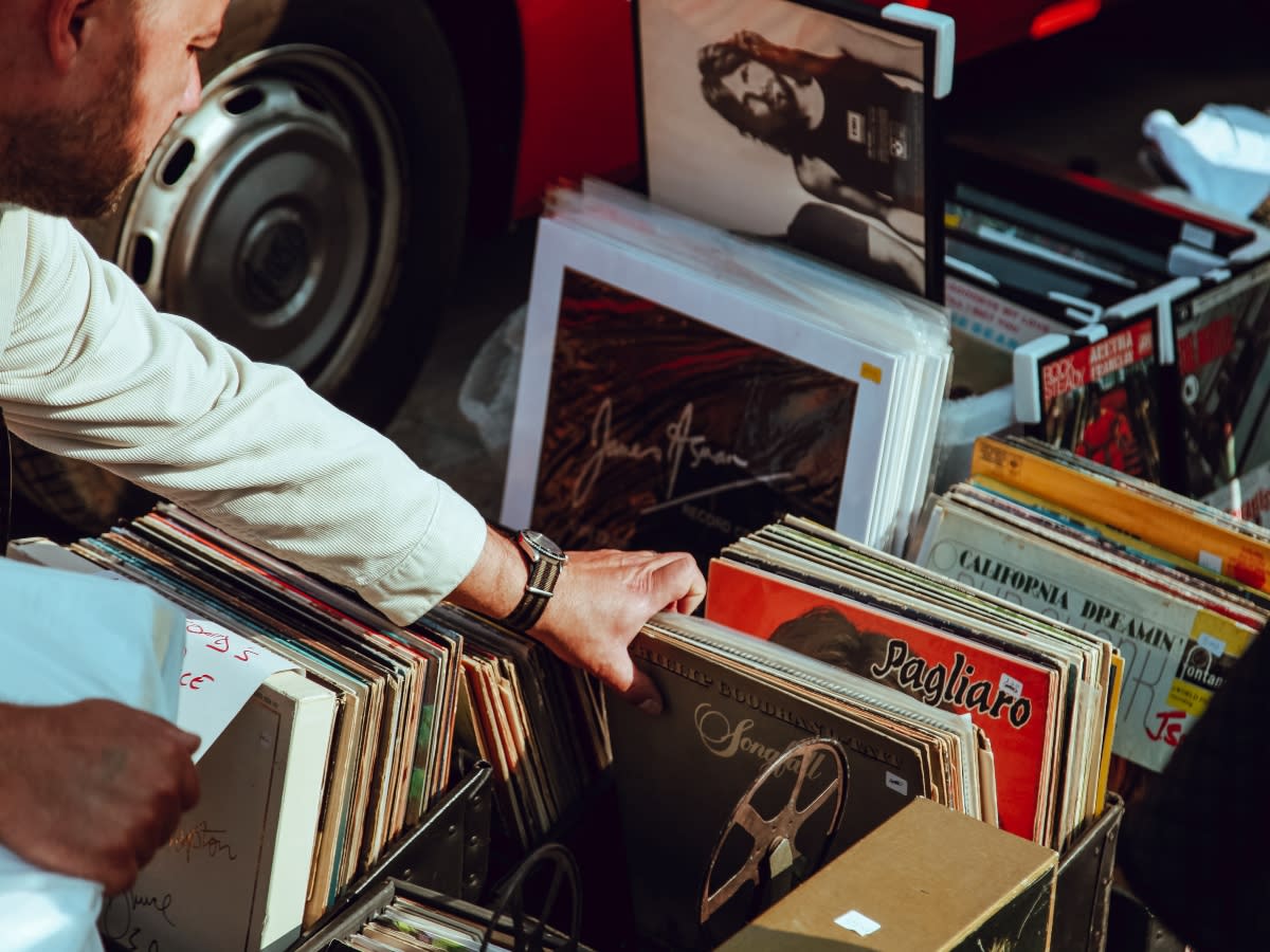 man sorting through vinyl records at a shop