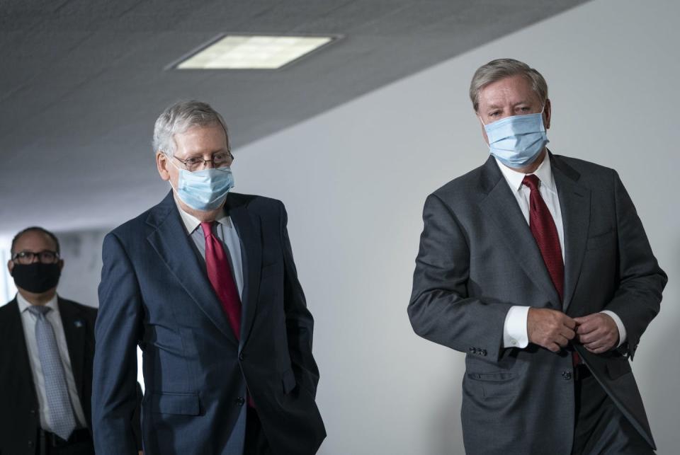 Senate Majority Leader Mitch McConnell and Sen. Lindsey Graham walking together