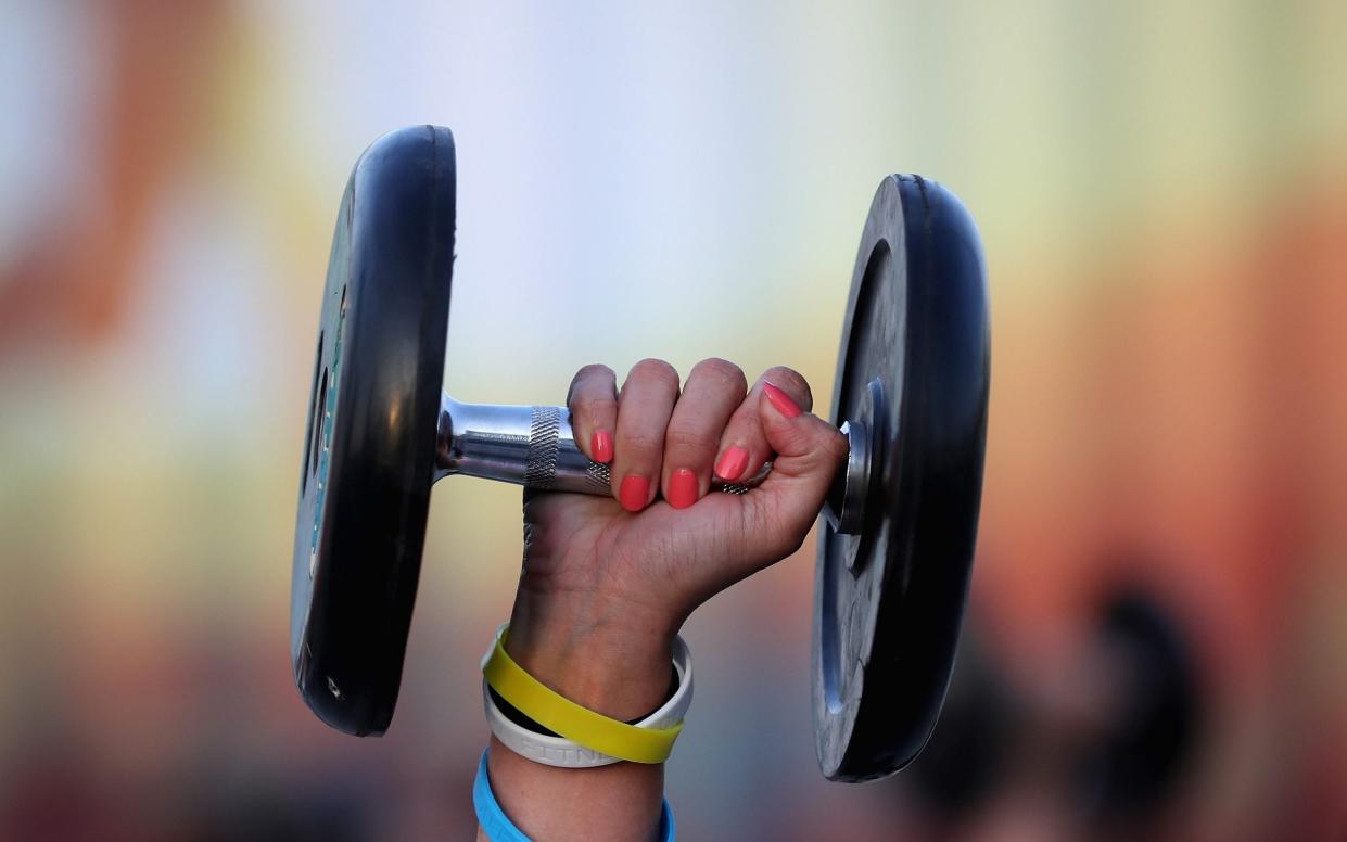 hand holding dumbbell - Francois Nel/Getty Images