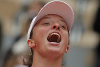 Poland's Iga Swiatek celebrates winning the final match of the French Open tennis tournament against Sofia Kenin of the U.S. in two sets, 6-4, 6-1, at the Roland Garros stadium in Paris, France, Saturday, Oct. 10, 2020. (AP Photo/Michel Euler)