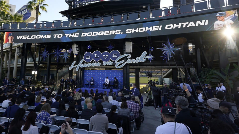 Los Angeles Dodgers' Shohei Ohtani, middle on stage, speaks during a baseball news conference at Dodger Stadium Thursday, Dec. 14, 2023, in Los Angeles. (AP Photo/Marcio Jose Sanchez)