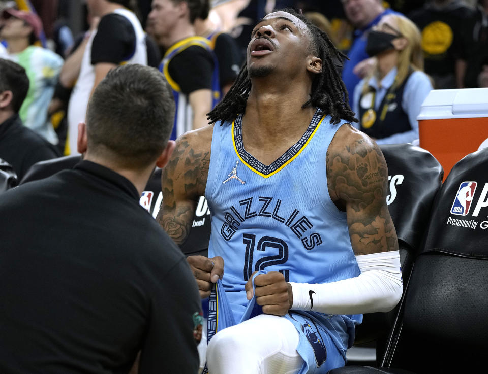 Memphis Grizzlies star Ja Morant sits on the bench and reacts after a team trainer examines his knee during a timeout against the Golden State Warriors in Game 3 of the Western Conference semifinals at Chase Center in San Francisco on May 7, 2022. (Thearon W. Henderson/Getty Images)