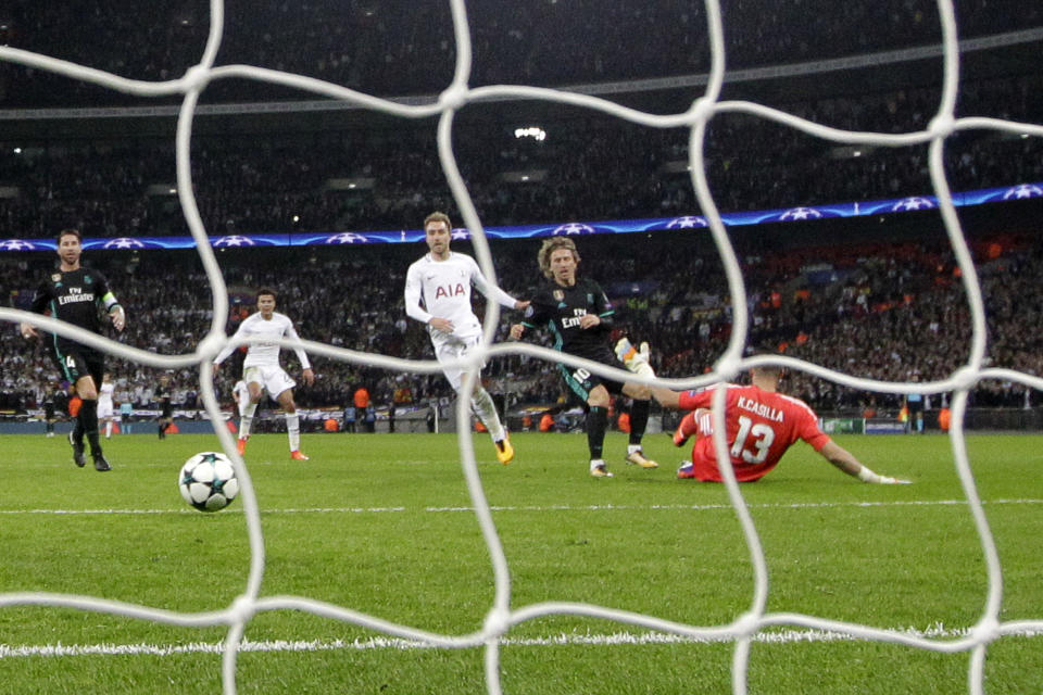 Tottenham’s Christian Eriksen, center in white, scores his side’s third goal leaving Real Madrid’s Luka Modric, second right, and Real Madrid’s goalkeeper Kiko Casilla defeated during a Champions League Group H soccer match between Tottenham Hotspurs and Real Madrid at the Wembley stadium in London, Wednesday, Nov. 1, 2017. (AP Photo/Matt Dunham)