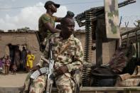 Nigerian soldiers on patrol in Banki to guard against infiltration or attack by Boko Haram insurgents