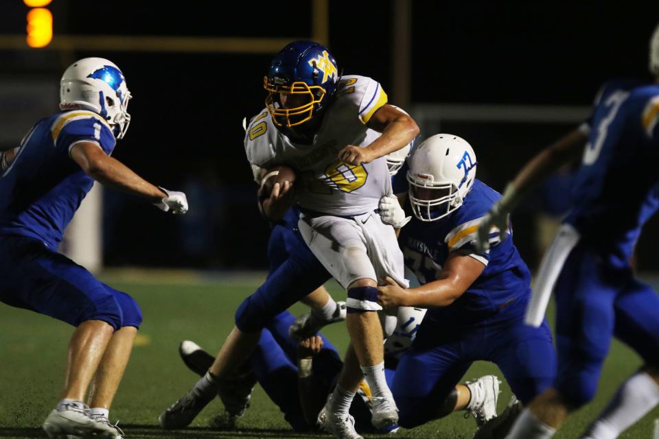 A host of Maysville defenders, including Gauge Samson, swarm West Muskingum's Harley Hopkins during a game in the regular season. Hopkins was recognized for his efforts, making first team All-Ohio in Division V, as that team was announced on Tuesday.