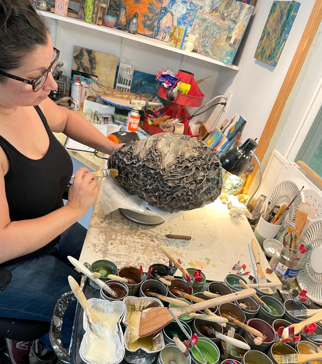 Regina Bos works on a piece. Bos was a recipient of an artist grant and has her work displayed at the Cleveland County Arts Council as part of a local artists exhibit.