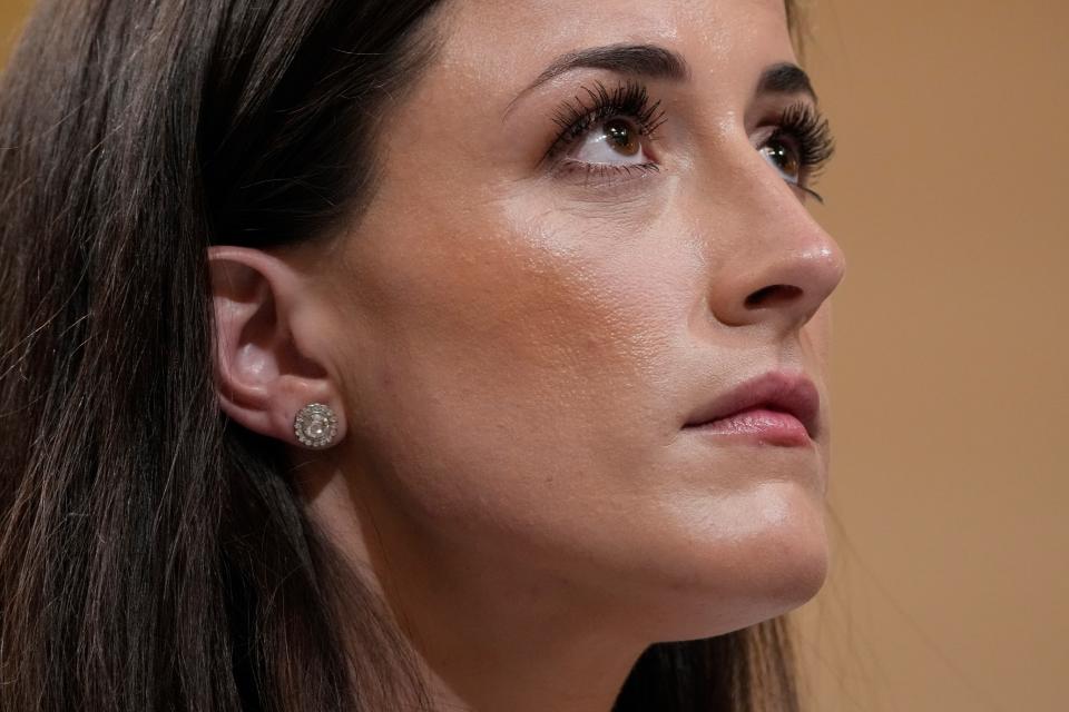 Cassidy Hutchinson, an aide to former White House chief of staff Mark Meadows, watches the video screen during her appearance before the House select committee investigating the Jan. 6 attack on the U.S. Capitol.