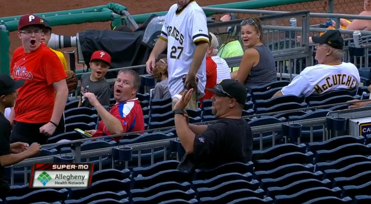 Pirates fan catches a foul ball at the Pirates-Phillies game on July 24, 2016.