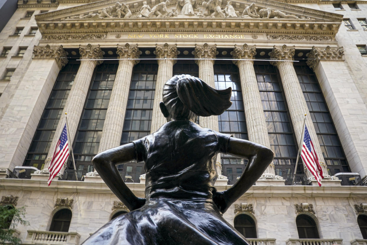 FILE- The Fearless Girl bronze sculpture looks towards the New York Stock Exchange from its roadside perch in New York on Aug. 25, 2020. The days when only men sat on U.S. corporate boards are nearly extinct. But the pace at which boards are moving toward gender parity has slowed, and it'll likely be a decade before they’re evenly split (AP Photo/Bebeto Matthews, File)