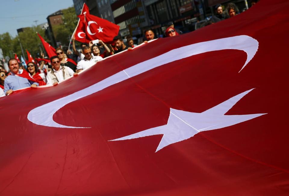 Demonstrators carry a huge Turkish flag during a demonstration including members of the Turkish ultra-nationalist organization called the Grey Wolves in Duesseldorf, western Germany, May 8, 2016. (Wolfgang Rattay/REUTERS)